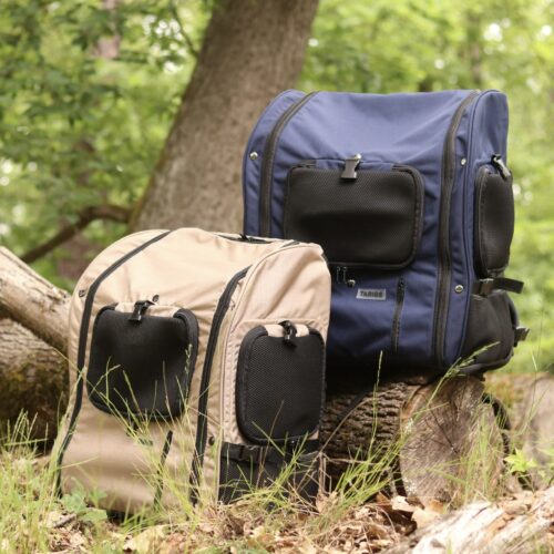 TARIGS Bulldog Backpacks in Cobalt Blue and Desert Sand on a tree trunk in the forest