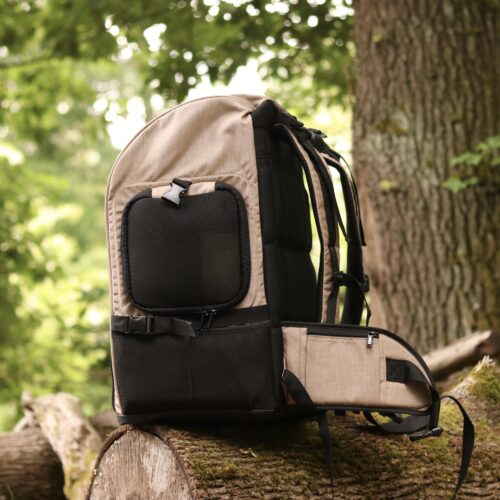 TARIGS Bulldog Backpack in Desert Sand sideways on a tree trunk, showing carrying system